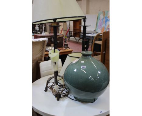 A pair of wrought iron table lamps, a similar pricket candlestick and a large ceramic lamp, green glaze and another lamp (4) 