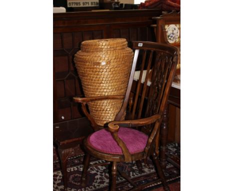 An Edwardian inlaid mahogany stick back open armchair, an Ali-Baba basket and a mahogany coffee table