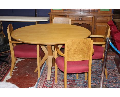 A Benchmark 'Jack' oak circular pedestal dining table with four 'crossover' legs, top diameter 135cm, makers plate numbered 4