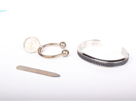 Paloma Picasso for Tiffany a stainless steel and titanium torque bangle; a Tiffany & Co silver torque key fob, import hallmar