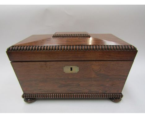 A William IV rosewood tea caddy of sarcophagus form, fitted interior, beaded rim, squashed bun feet 