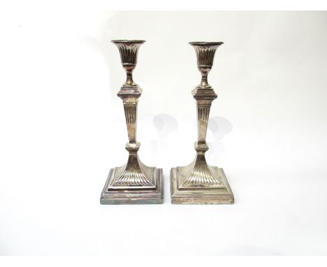 A pair of William Hutton and Sons silver candlesticks, marked London 1901. 29.5cm high.