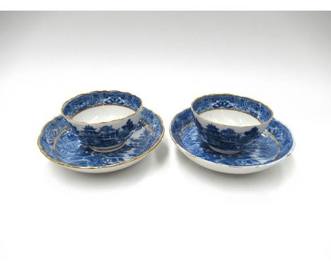 A pair of Caughley blue and white tea bowls, Willow pattern, small chips and cracks to bowl. Firing crack to saucer foot rim