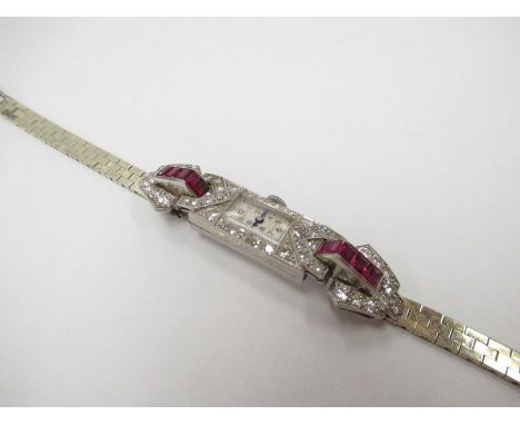 An Art Deco white gold cocktail watch with rubies and diamonds, with later 9ct gold strap, 26g, split and chip to top ruby&nb