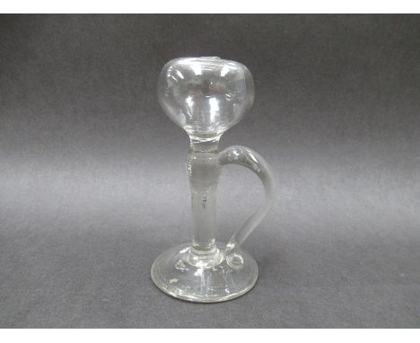 A mid 18th Century clear glass lace maker's lamp, c.1760, with side handle and pontil mark to base. 13cm tall