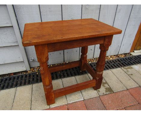 A Robert Thompson "Mouseman" oak stool. 39cm high.