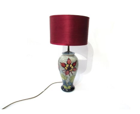 A Moorcroft Aquilegia pattern table lamp base on blue ground, 33cm tall