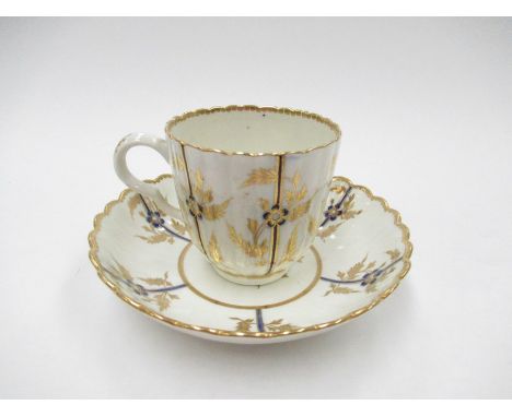 A late 18th Century Caughley teacup and saucer, the fluted body painted with panels of flowers, circa 1775-80