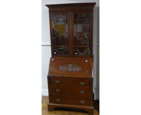 A 20thC mahogany Bureau Bookcase, the moulded cornice above astragal glazed doors enclosing shelved interior, fall front Bure