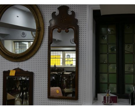 A Georgian walnut cushion frame Wall Mirror, the top with ebony and boxwood inlaid star, 16in (40cm) x 48in (121cm) 