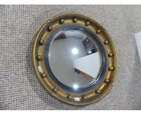 A 19thC Regency-style convex Mirror, the convexed plate within gilt wooden frame with ball finials, some damaged,&nbsp;17in (