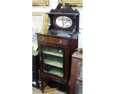 An Edwardian walnut mirror-back sheet music Cabinet, with inlaid decoration, the raised back above a frieze drawer and glazed