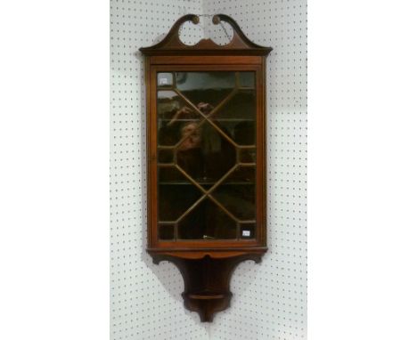 An Edwardian mahogany corner Cabinet, with swan-neck pediment and astragal glazing, 18in (45.5cm) wide x 9in (23cm) deep x 45