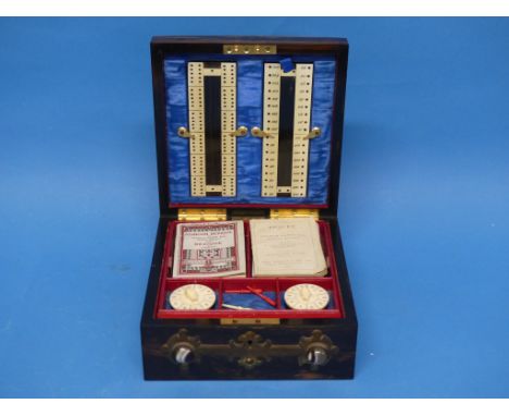 A Victorian Games Compendium, containing cribbage board, whist markers, counters, playing cards, rule booklets for Piquet and