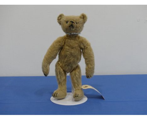 An early 20thC German mohair Bear,&nbsp;possibly Steiff but no button, with rounded 'hump' back and in golden mohair with woo