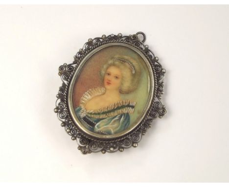 PORTRAIT PIN.A white metal brooch/pendant set a hand painted portrait miniature, indistinctly initialled GL. Portrait 3.5 x 3