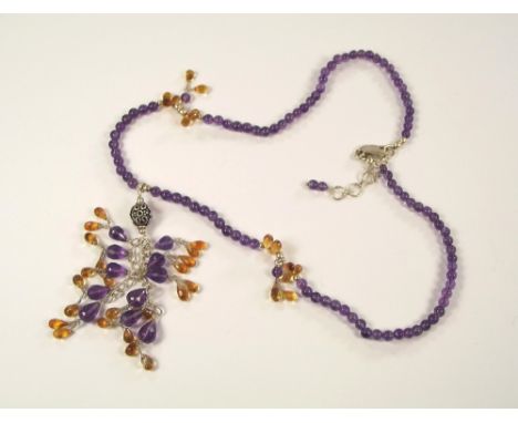 GEMSTONE NECKLACE. A silver mounted amethyst & citrine drop necklace. Length 45cm. Length of drop 9cm.