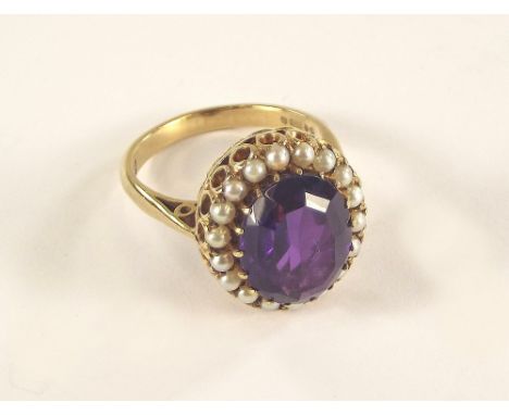 AMETHYST RING. A 5ct. dark amethyst & seed pearl cluster ring in 9ct. gold setting. Size O.