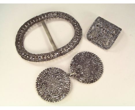 CUT STEEL. A French 19th century cut steel, curved buckle, 6 x 5.5cm. Also a very large cut steel buckle, 13.5 x 10.5cm & a c