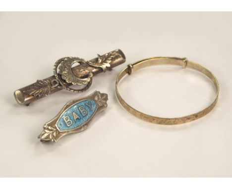 BABY PIN ETC.An early 20th century silver & enamel baby pin, a baby's expanding bracelet & a late Victorian bar brooch.