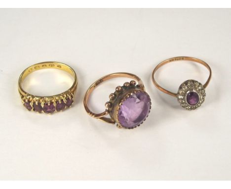 DRESS RINGS. A 22ct. gold five stone amethyst dress ring, a large amethyst dress ring & a 9ct. gold amethyst & paste cluster 