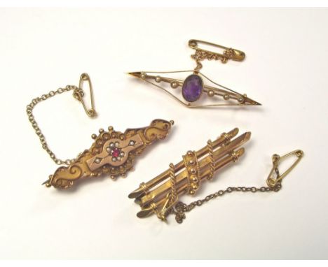 AMETHYST BROOCH ETC. A 15ct. gold amethyst & half pearl brooch, a 9ct. gold garnet & half pearl brooch & one other brooch.