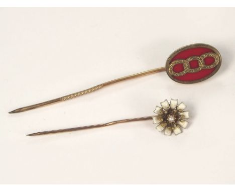 STICK PINS. A white enamel & half pearl flowerhead stick pin & one other stick pin.