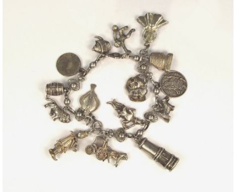 CHARM BRACELET.A fancy link charm bracelet hung with charms to include a miner's lamp, an articulated clown & a plaice.