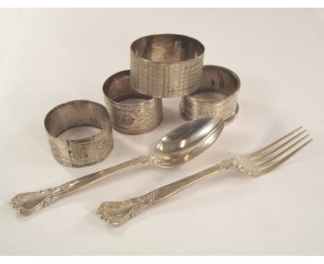 NAPKIN RINGS ETC.Four various engine turned napkin rings & an American sterling silver spoon & fork set.