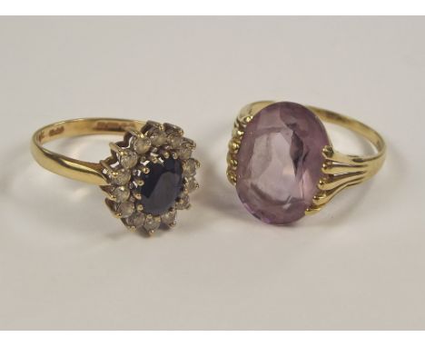 DRESS RINGS. A 9ct. gold amethyst set dress ring & a 9ct. gold cluster ring.