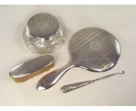 SILVER MIRROR ETC. An engine turned silver mounted hand mirror, with matching brush & powder bowl. Also, a silver mounted but