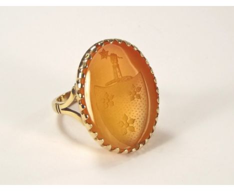 GOLD RING. A pale carnelian armorial ring, the stone set in 9ct. gold. Size of intaglio 2.6 x 2cm.