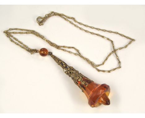 ART DECO PENDANT. An Art Deco brass mounted amber glass pendant with chain.