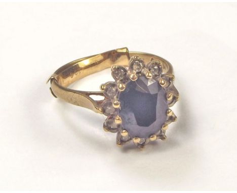 GOLD RING. A 9ct. gold & sapphire set dress ring. Size K.