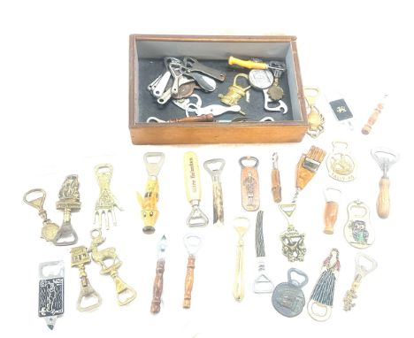 Large selection of vintage Novelty bottle openers in a display case/ drawer 