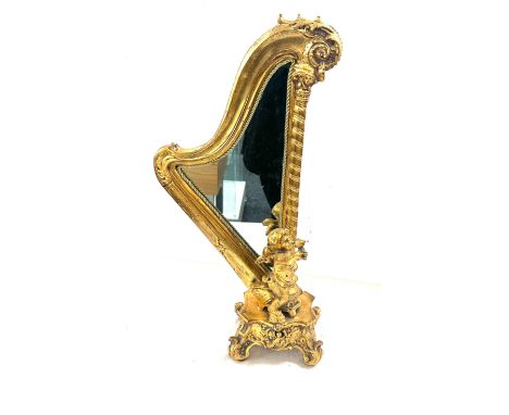 Gilt harp shaped cherub table mirror, overall height 24 inches 