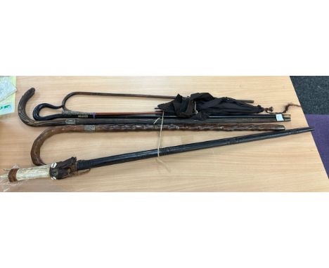 Selection of vintage walking sticks/ umbrellas includes silver rimed etc 