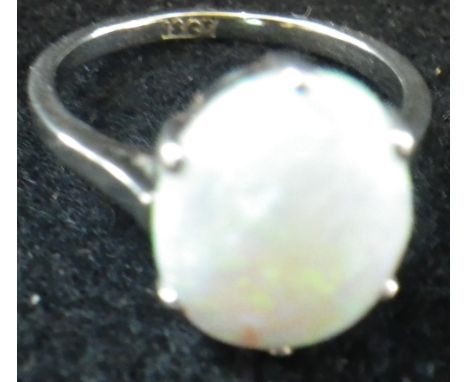 A WHITE OPAL DRESS RING on an 18ct white gold shank, ring size K