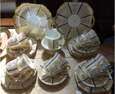 A VINTAGE NORITAKE TEASET in yellow and gilt, with blue lines