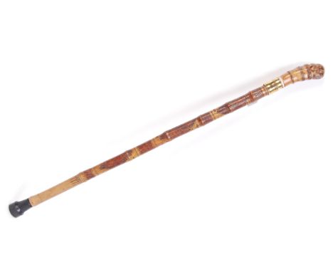 An antique 19th century Chinese bamboo made sword walking stick cane. The bamboo shaft decorated with carved scenes of orient