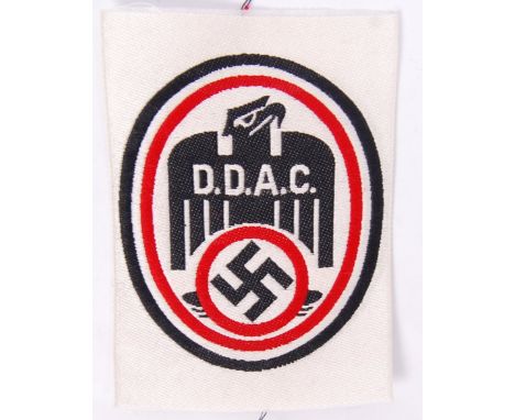 An original Nazi German Third Reich D.D.A.C. Der Deutsche Automobil- club cloth patch, with eagle swastika emblem to front. M
