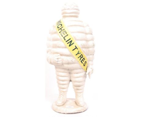 A vintage style 20th century large cast iron advertising figure of Bibendum ( the Michelin Tyres Man ) with yellow sash and h