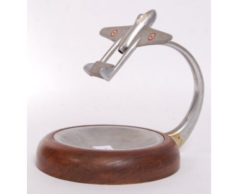 A good mid-century circa 1950's made steel and wood ashtray, with a mounted De Havilland Vampire aeroplane to the top. Mounte