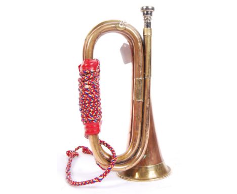 An original WWI First World War military bugle with decorative roped cords &amp; chrome mouthpiece. Measures approx 30cm tall