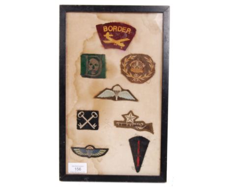 A framed collection of original British WWII Second World War uniform patches to include; No.3 Commando ' D ' with skull patc