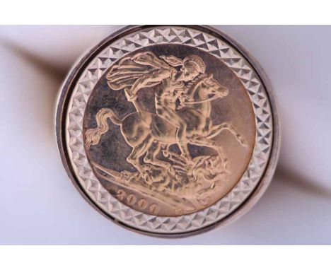 ELIZABETH II GOLD FULL SOVEREIGN DATED 2000
mounted in a nine carat gold ring; along with a 1/10 Kruggerrand dated 1982 mount