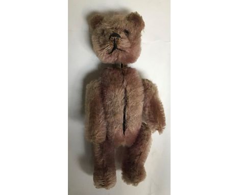 Schuco Compact Bear. A rare compact fully jointed Teddy Bear from 1927, made in Germany by Schuco.measures 9cm tall, has hing
