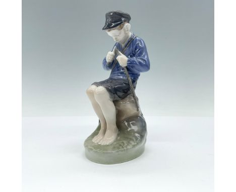 Glazed; Young boy, sitting down, whittling a stick. Royal Copenhagen backstamp. Artist: Christian ThomsenIssued: 1968Dimensio
