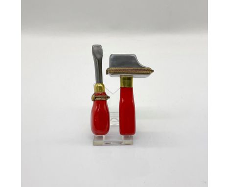Hand painted porcelain treasure boxes in the shape of a Flat head Screwdriver and a Hammer. Both pieces have a stainless stee
