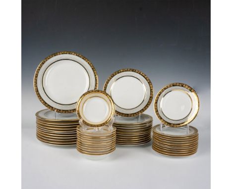 White fine china decorated in 22kt gold trims, the edge features an acid-etching clover pattern over the gold band. Set inclu